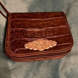 Genuine Leather Brown Croc embellished with silver medallion. 8.5 x 6 inches